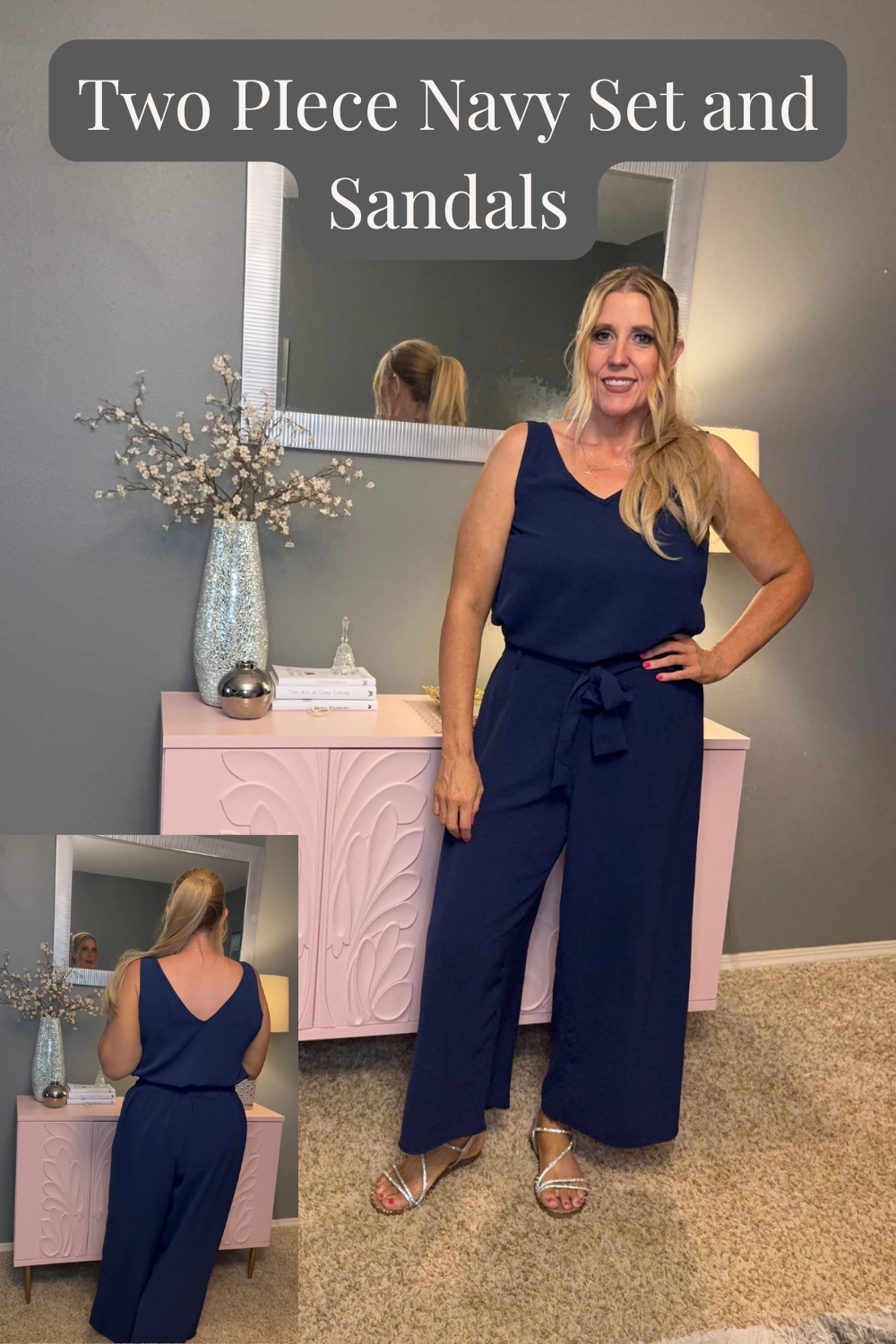 Woman wearing a navy two‑piece outfit with a sleeveless top and tie‑waist pants, styled with silver sandals in a cozy bedroom setting.