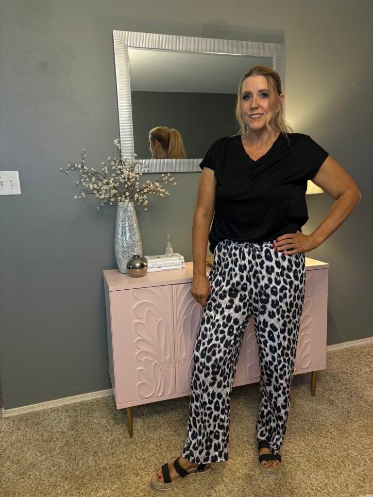 woman with animal print pants and black top